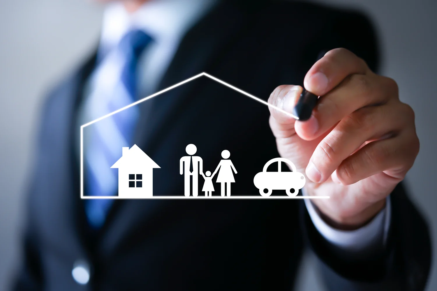Independent insurance broker sketching a family home and car on a transparent board, representing insurance solutions.